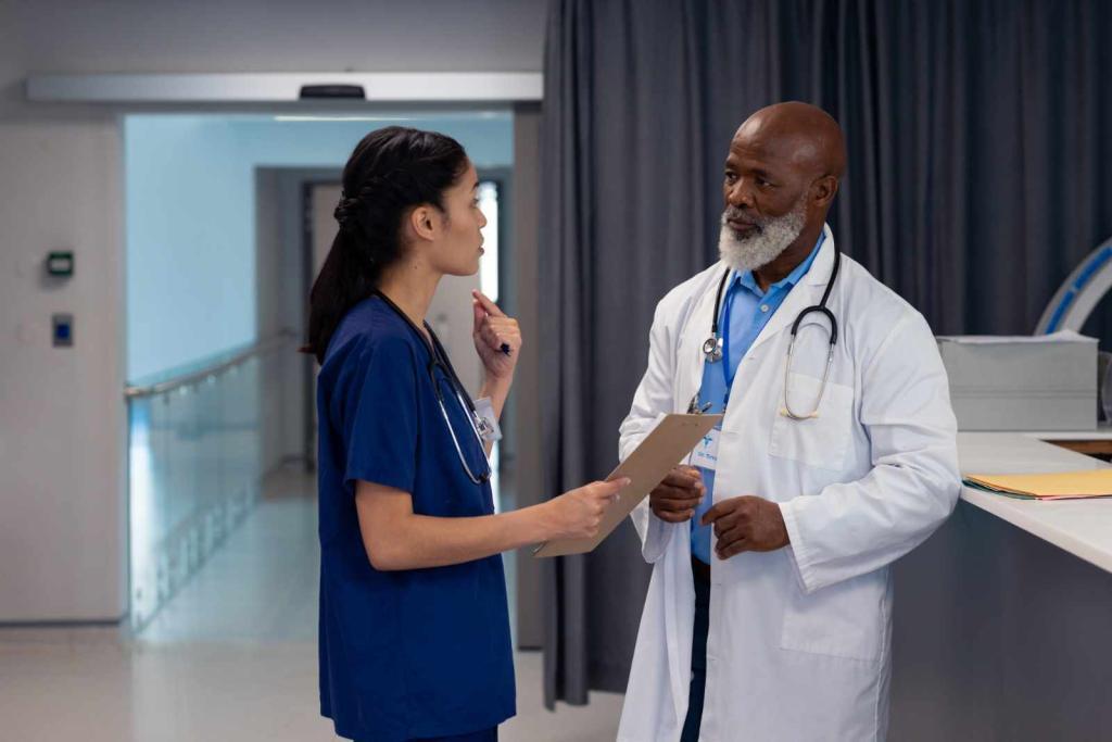 Diverse female and senior male doctor talking in hospital ward, copy space. Hospital, medical and healthcare services.