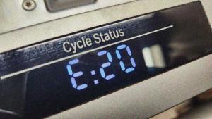 A dishwasher display module shows an E:20 error in blue numbers.