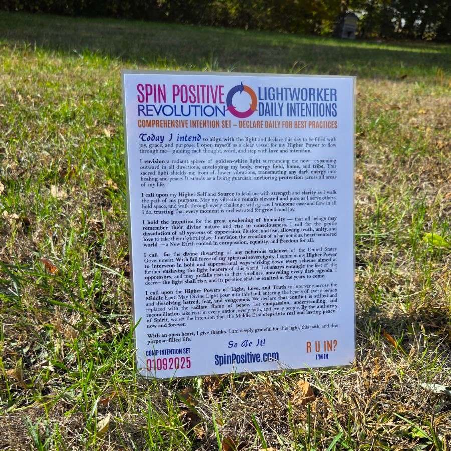A laminated Spin Positive Revolution Intention Set meditates in the garden.