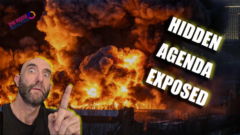 In the background, there is a violent explosion with a large fireball and huge plume of dark, choking, smoke. In front of the explosion, and rising from the lower left hand corner is a handsome Mojoe Mike with a surprised look upon his face pointing toward the distruction. Above him, and tilted about sixty degrees counter-clockwise is the Spin Positive Revolution logo complete with the tri-arrow logo. On the right side, and also tilted are the words in large, Impact typeface "Hidden Agenda Exposed"